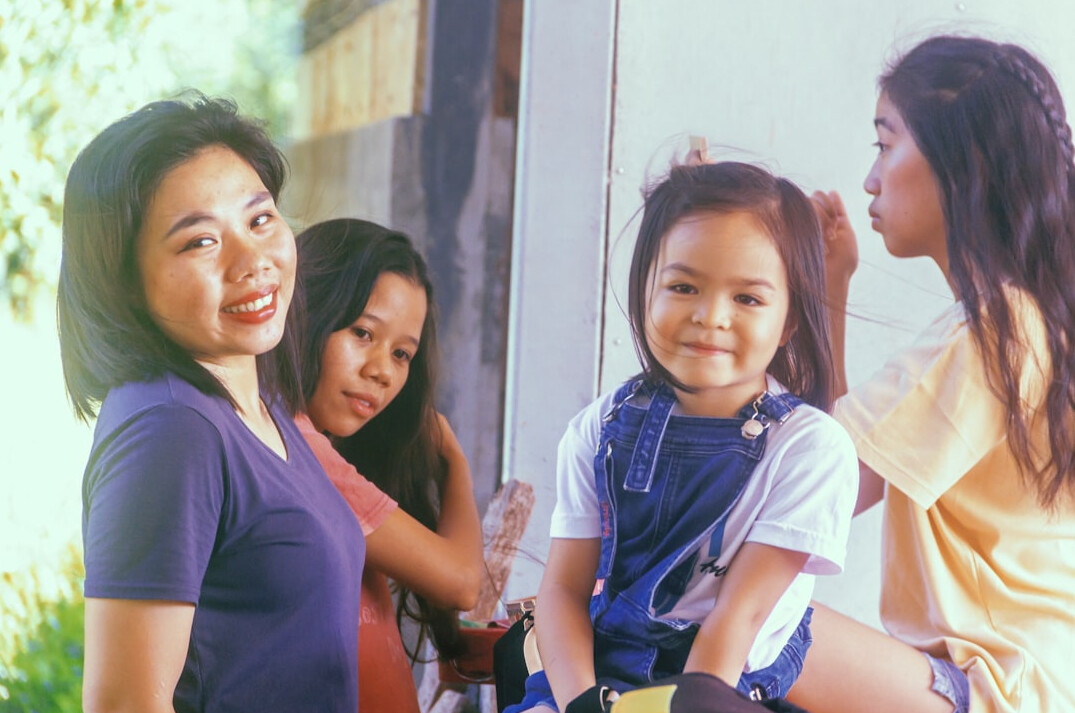 Asian family smiling with doctor during a health checkup