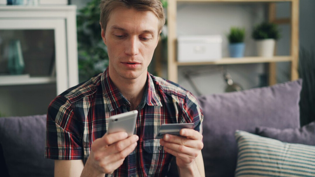 Asian man reviewing a health insurance claim on his laptop at home